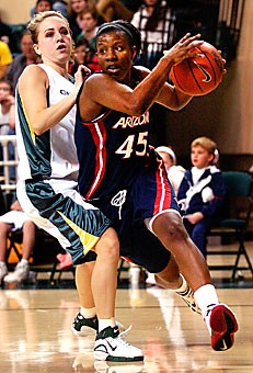 Arizona guard Joy Hollingsworth charges to the basket past Oregons Taylor Lilley in an attempt to set up a two-point basket during Thursday nights away game at the University of Oregon. The Wildcats had a surge of scoring late in the second half but could not overcome Oregons offensive game, losing 86-73.
