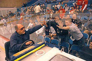 Tucson Convention Center Zamboni driver Norm Rendfrey rides by fans during the first intermission of the Icecats' game against ASU Dec. 8. Rendfrey has driven the Zamboni for more than 20 years.