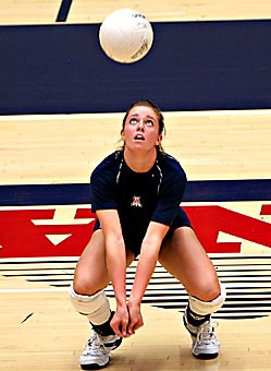 Outside hitter turned libero Alanna Resch crouches for a dig during practice yesterday in McKale Center. The 5-foot-9 sophomore played her first game as a libero against Kentucky last weekend, tallying 15 digs. 