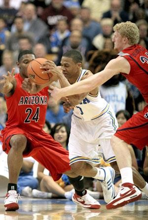 UCLA guard Russell Westbrook splits UA forwards Fendi Onobun (left) and Chase Budinger during the Wildcats 82-60 loss Saturday in Pauley Pavilion. After falling behind by 20 at halftime, Arizona failed to make one of its patented comebacks and trailed by as much as 32 at one point.