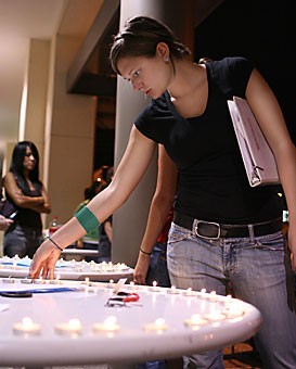 Shelby Harchar, a senior majoring in deaf studies, lights a candle at the STAND rally to save Darfur yesterday evening at the Second Street Parking Gargage. STAND members fasted for the day and donated money to the U.N. Food Programme to show their support for Darfur.