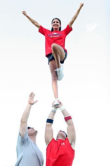 Communication senior Andrew Bryce and pre-business sophomore Austin Singer practice partner stunting outside McKale Center Monday afternoon.  Under proposed guidelines, Pac-10 cheerleaders would not be allowed to perform partner stunting or have their feet leave the ground.
