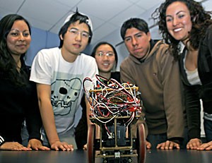From left, electrical engineering junior Tanuja Mouli, computer engineering senior Andy Yan, electrical engineering sophomore Michelle Ho, senior Alonso Montesinos and junior Denise Hernandez stand behind their mechanical mouse, which won a competition Saturday in Las Vegas by navigating a labyrinth without a remote.
