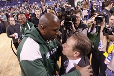 Michigan State head coach Tom Izzo, right, is embraced by former Michigan State star and current NBA Hall-of-Famer Magic Johnson after the Spartans defeated No. 1-seed Louisville 64-52 in Lucas Oil Stadium on Sunday afternoon. 