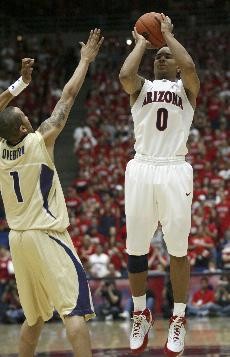 UA guard Jerryd Bayless shoots over UW guard Venoy Overton in Saturdays 89-64 Wildcat win over Washington in McKale Center. Bayless scored 26 points, shooting 9-for-11 from the field, and dished out six assists.