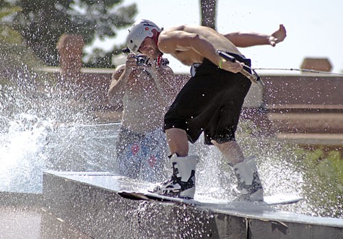 Trevor Marquette spins a 360 degree turn on a rail from about 20 feet high as he is pulled into a shallow pool set up on the UA Mall yesterday afternoon. Wakeboarders performed stunts all day during the second annual Rail Jam.