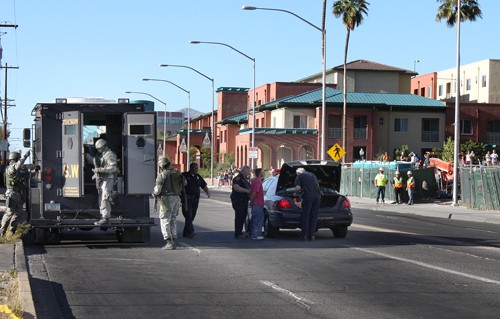 Lisa Beth Earle/ Arizona Daily Wildcat

A S.W.A.T. team packs up to leave while Tucson Police Department officers take a man into custody who barricaded himself in an apartment with a knife like weapon across the street of the dormitory construction on Euclid Avenue and Sixth Street Thursday afternoon.
