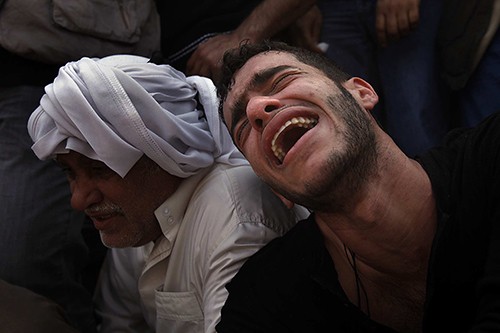 Hussein Abdullah, 19, cries out at the funeral of his best friend Ali Ahmed Al Muameen, 23, who was killed by security forces in Bahrain as they cracked down on anti-government protesters, Friday, February 18, 2011. (Rick Loomis/Los Angeles Times/MCT)