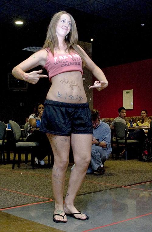 Katie McCallister, a sophomore majoring in family studies and human development, walks down the catwalk at the real women fashion show in the Cellar last night, where the models wore whatever they wanted.  McCallisters stomach reads Bikini worthy, because I said so.