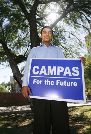 History sophomore and Democratic candidate for the Cochise County Board of Supervisors Chris Campas poses with one of the many campaign signs that dot the streets of Sierra Vista.