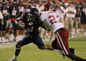 UA running back Nic Grigsby attempts to break a tackle from Washington States Husain Abdullah in last years 48-20 win over the Cougars at Arizona Stadium. Despite being 39-point favorites heading into Saturdays game in Pullman, Wash., the Wildcats wont take their opponent lightly.