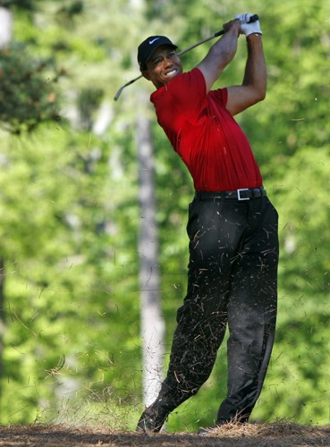 Tiger Woods blasts out of the pine straw on No. 11 during the final round of the Masters at Augusta National Golf Club in Augusta, Georgia, on Sunday, April 11, 2010. (Gerry Melendez/The State/MCT)