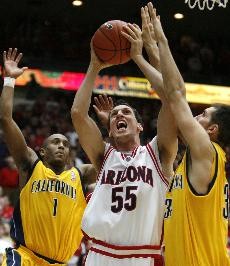Arizona forward Ivan Radenovic goes up for a shot between Cal guard Ayinde Ubaka, left, and forward Ryan Anderson during the Wildcats 94-85 win over the Golden Bears Thursday in McKale Center. Radenovic and the No. 7 Wildcats host Stanford Saturday at noon in a game televised nationally on FSN.