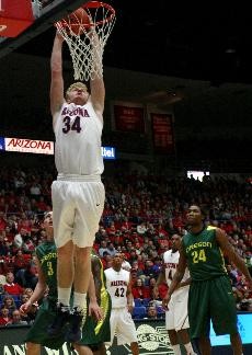UA forward Chase Budinger slams home two of his game-high 20 points in Thursday nights 67-52 win over Oregon in McKale Center. Budingers performance was a slump-buster after he shot just 12-for-50 from the floor over his previous four games.