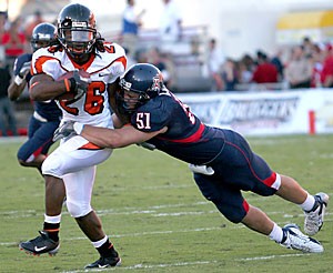 Oregon State running back Yvenson Bernard cant escape the grasp of junior linebacker Spencer Larsen in Arizonas 17-10 loss to the Beavers in Arizona Stadium on Oct. 21. Larsen and the Wildcats defense have jumped from ninth in the Pacific 10 Conference to fourth against the rush this season, allowing 105.8 yards per game. 