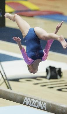 UA freshman Rebecca Cardenas performs her routine on the uneven bars during a loss to No. 4 Stanford Friday night in McKale Center.