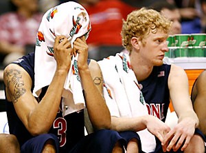 Arizona forward Marcus Williams, center, covers his face as fellow forward Chase Budinger looks on during the final seconds of the second half of No. 5 seed Arizonas 69-50 Pac-10 Tournament quarterfinal loss to No. 4 seed Oregon yesterday at Staples Center. The duo combined to shoot 10-of-31 (32.3 percent) for an Arizona squad that shot 35 percent for the game and scored its lowest point total of the season by 11 points.