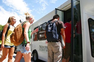 Students from NorthPointe Student Apartments make use of their shuttle yesterday afternoon in front of Old Main. The shuttle is one of several from different apartments that provide students an alternative to driving.