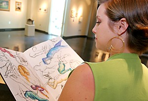 Jake Lacey /Arizona Daily Wildcat

Graduate Assistant of the Art Galleries, Shelbye Reese looks through one of the ten journals she plans on displaying in the Art Gallery of the Student Union. Reese plans on creating a similar program as the one found on www.1000journals.com.