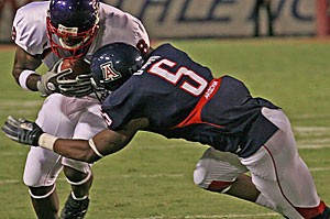 Junior cornerback Antoine Cason puts a hit on Stephen F. Austin wide receiver Dominique Edison Saturday at Arizona Stadium. Cason will have bigger fish to fry this week in USC wide receivers Dwayne Jarrett and Steve Smith. 