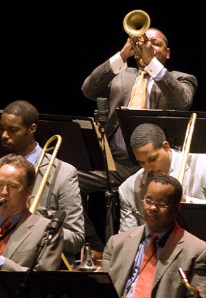 Renowned jazz musician Wynton Marsalis, top, trumpets laid-back, energetic and sometimes whimsical tunes with the Jazz Lincoln Center Orchestra, of which he is the music director, at Centennial Hall Tuesday night. As the resident orchestra of the Lincoln Center for 13 years, the group has included jazz masters such as Duke Ellington, Ted Nash and John Coltrane.