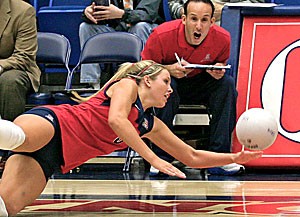 Sophomore libero Brittany Leonard lays out for a ball during Arizonas four-set loss to No. 6 Washington Friday in front of assistant coach Chris Gonzalez.