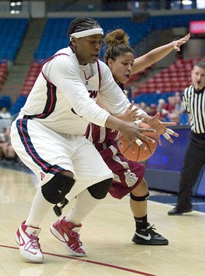Junior forward Amina Njonkou fights for a loose ball in Arizonas 67-54 loss to Washington State Saturday in McKale Center. The game marked the Wildcats last home contest of the season.