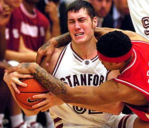 Arizonas Chris Rodgers tries to pull the ball away from Stanfords Matt Haryasz during the second half of Arizonas game against Stanford, Sunday, Feb. 19, 2006 at Maples Pavilion in Stanford, Calif. Arizona beat Stanford 76-72. (Photo by Chris Coduto/Arizona Daily Wildcat)
