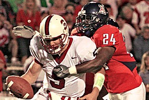 Arizona linebacker Marcus Hollingsworth wraps his arms around Stanford quarterback Trent Edwards during last years 20-16 loss to the Cardinal on Oct. 15, 2005. Edwards has thrown for one touchdown and five interceptions in the last four games, but threw for two touchdowns against Arizona last year. The Cardinal have won the last three meetings against the Wildcats.
