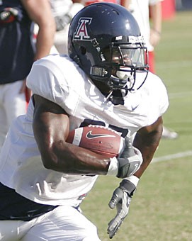Arizona running back Nick Grigsby runs drills during practice yesterday. The true freshman should get playing time against NAU on Saturday, head coach Mike Stoops said.