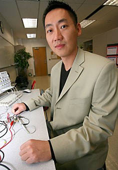 Dongsheng Ma displays the chip at the heart of high-definition radio in his lab at the Electrical Engineering building yesterday. Ma is collaborating with Texas Instruments to help develop this higher quality over-the-air radio.