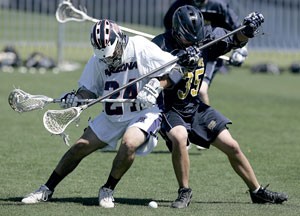 Arizona lacrosse midfielder Curtis Fillmore battles UCSD defenseman Coleman Peng for the ball during the Laxcats 10-9 win March 29 at Murphey Field at Lohse Stadium. The Laxcats head to California this weekend to play No. 2 Chapman University in the Mens Collegiate Lacrosse Association National Championships.
