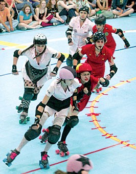 Rollergirls glide around the track during a bout between the Furious Truckstop Waitresses and the Iron Curtain held last Saturday at Bladeworld.