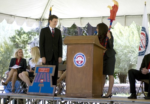 Tim Glass / Arizona Daily Wildcat 

Outgoing Associated Students of the University of Arizona Administrative Vice President Gariella Ziccarelli passes the vice-presidential A and war-stick on to incoming Administrative Vice President Brett Ponton at the ASUA inauguration in front of Old Main, Monday, May 3, 2010.