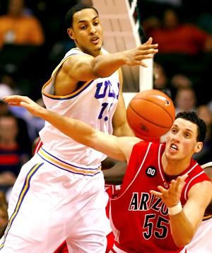 Arizonas Ivan Radenovic tries to grab a loose ball from UCLAs Ryan Hollins during the first half of Arizonas semi-final Pac-10 Tournament game against UCLA, Friday, March 10, 2006 at the Staples Center in Los Angeles. (Photo by Chris Coduto/Arizona Daily Wildcat)