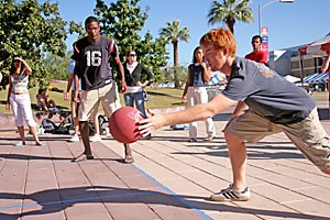 Molecular and cellular biology junior Quincy Johnson, left, and pre-business sophomore Kyle Speck participate in a four-square game in Alumni Plaza yesterday. A couple of students taped off the court on the ground, and several students walking by joined in.