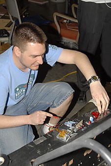 Jarod Prosise, a 2006 computer science alumnus, makes adjustments to the UA solar car yesterday evening at the Aerospace and Mechanical Engineering building. His team has been working out the kinks of the solar-powered vehicle for some time. 