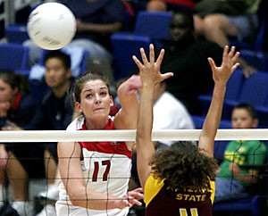 Arizona sophomore opposite player Randy Goodenough hits the ball over the net in the Wildcats four-set loss to ASU Friday in McKale Center. Goodenough recorded 14 kills in the game, second on the team to sophomore outside hitter Brooke Buringruds 15.