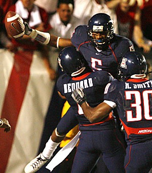 Antoine Cason is hoisted by teammates B.J. Dennard and Xavier Smith after scoring a touchdown on a 56-yard punt return in the second quarter of Arizonas 34-24 win over No. 2 Oregon on Thursday. Cason was named the nations  Defensive Player of the Week by the Walter Camp Football Foundation.