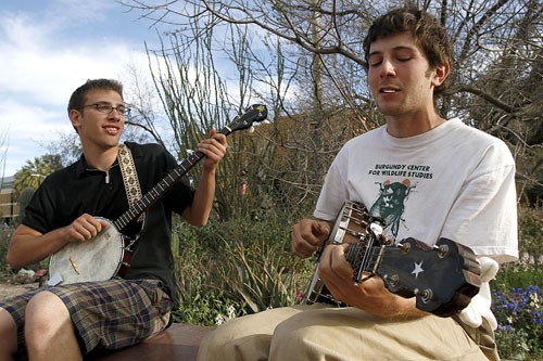 Adam Westreich, a communications junior, left, and Deep Sea, a visitor from Virginia, met and decided to jam on their banjos on the UA Mall on March 13 before the start of spring break.