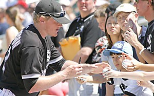 Chicago White Soxs Brian Anderson signs autographs for the fans before the start of a game against the Texas Rangers at Tucson Electric Park in a spring training baseball game Sunday. Anderson, a former UA star, is batting .279 so far in spring training and is battling for his job in the majors.