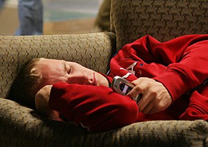 Jacob Ufford, a mathematics junior, breaks from a nap to text message a friend yesterday morning. Ufford and other students enjoy the plush couches in the TV Lounge located on the first floor of the Student Union Memorial Center.