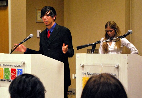Valentina Martinelli /Arizona Daily Wildcat

Raymond Arvizu, a political science freshman, answers questions at the ASUA senate debate while Taylor Bilby, a pre-business freshman, waits her turn along with other candidates to speak on March 4, 2010. 
