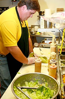 Joe Sullivan, an assistant manager at IQ Fresh, prepares a vegetarian Oriental noodle wrap Friday afternoon. PETA2, a youth group associated with the People for the Ethical Treatment of Animals, has nominated the UA for the 'most vegetarian-friendly colleges in America' list. 