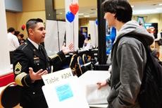 Sergeant First Class Julian Gonzalez, a U.S. Army recruiter, speaks with a student at the UA Career Day held in the Grand Ballroom of the Student Union Memorial Center yesterday afternoon.