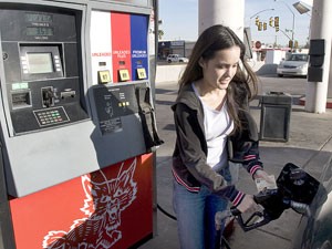 Psychology senior Mary Loy finishes filling her gas tank at Jetts Wildcat Petrol yesterday afternoon.