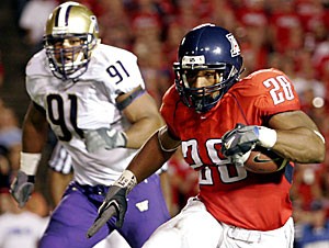 Junior running back Chris Jennings looks for open space as he carries the ball in the first quarter of Arizonaa 21-10 loss to Washington on Saturday at Arizona Stadium. The Wildcats havent found much open space so far this year, ranking 113th in the country in rushing yards per game.