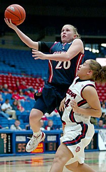 Junior guard Jessica Arnold drives past sophomore guard Malia ONeal last night during the Red-Blue Game in McKale Center. Arnold finished with 12 points on just 5-of-20 shooting as the Red Team beat the Blue Team 100-61 in a contest that involved many players switching teams.