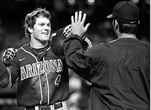 Arizona right fielder Jon Gaston is congratulated by closer Daniel Schlereth when scoring a run shortly after belting a triple to the right field wall. Gaston, who was named the games MVP, and the Wildcats got their revenge on No. 16 ASU, 6-5.