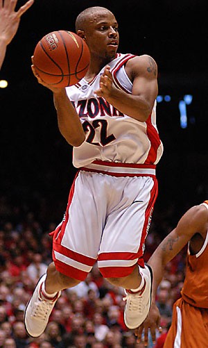 Then-senior guard Jason Gardner passes during the first half in the 73-70 win over Texas on Dec. 15, 2002, in McKale Center. Though current guard Nic Wise hasnt matched Gardners numbers, he may be comparably important to this years team. 